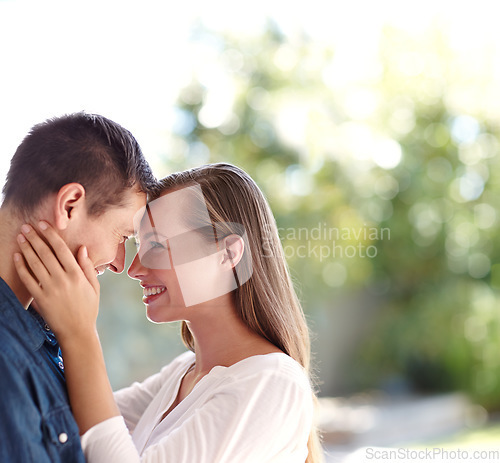 Image of She finally got her happily ever after. A young couple holding each other as they stand outside.