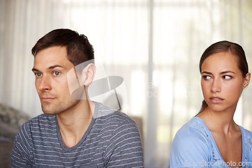 Image of If he only knew. Shot of a young couple having a disagreement at home.