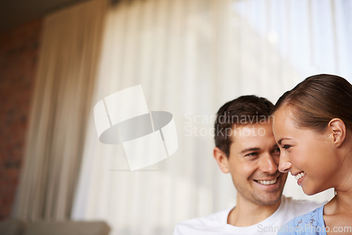 Image of Who needs anyone else. Shot of a happy young couple sitting together inside.