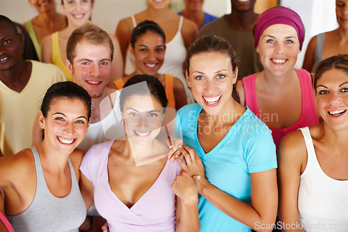 Image of Yoga portraits. Portrait of a a group of yoga enthusiasts standing in a yoga studio.