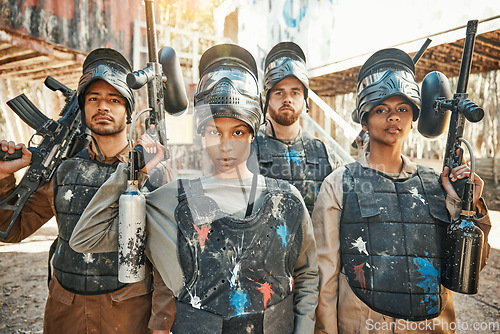 Image of Paintball, serious and portrait of team or people ready for a battle and teamwork or collaboration together. Concentrate, sports and army on a mission on the battlefield with guns for competition