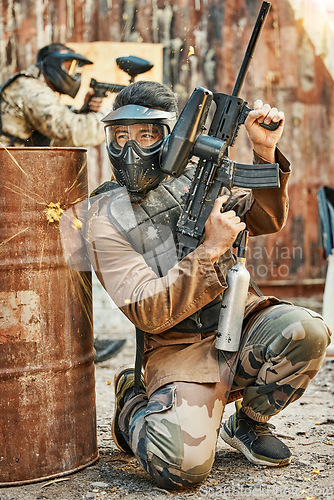 Image of Paintball, soldier and man with gun for tournament, competition and battle in arena. Extreme sports, military and male person shooting in outdoor gear for training, adventure games and challenge