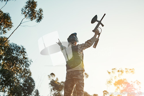 Image of Paintball game, winning and woman celebrate battlefield success, military training achievement or victory. Army mission, nature sky and back of female winner of competition, war conflict or challenge