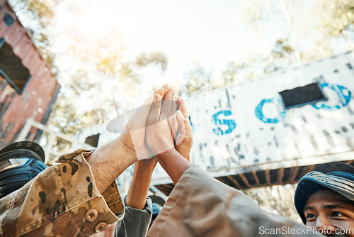 Image of Paintball, hands and high five for teamwork, support or trust in game plan, collaboration or unity on battle field. Group of paintballers touching hand for team building motivation before match start