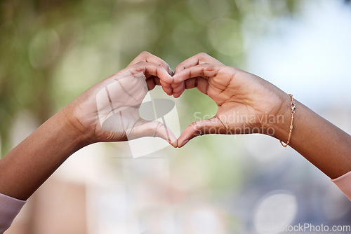 Image of Woman, heart hands and love in nature for compassion, romance or care against a blurred background. Closeup of female person with loving symbol, gesture or sign for valentines day in the outdoors