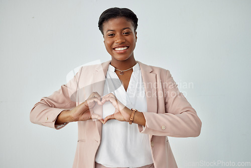 Image of Happy black woman, portrait and heart hands for love, care or compassion against a white studio background. African female person with loving emoji, symbol and sign or hand gesture on mockup space