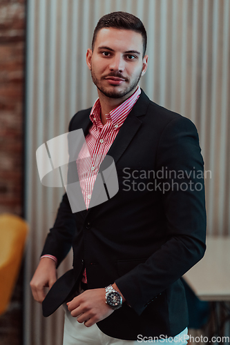 Image of Portrait of a young businessman in a modern suit. Portrait of the company director in his office. Selective focus