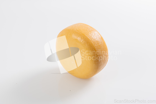 Image of A piece of fresh processed cheese isolated on a white background