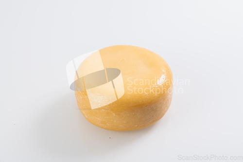 Image of A piece of fresh processed cheese isolated on a white background