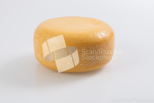 Image of A piece of fresh processed cheese isolated on a white background