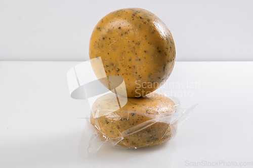 Image of A piece of homemade vacuumed traditional Bosnian cheese isolated on a white background