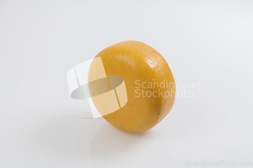 Image of A piece of fresh processed cheese isolated on a white background