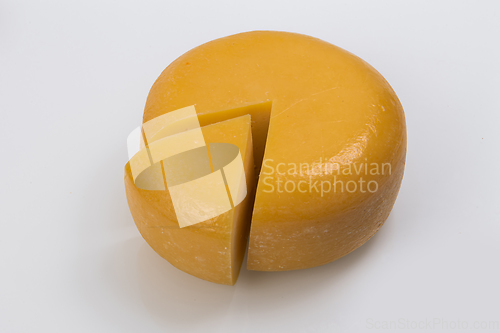 Image of A piece of fresh processed cheese isolated on a white background