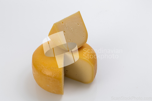 Image of A piece of fresh processed cheese isolated on a white background