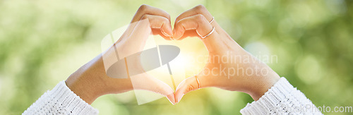 Image of Love, heart and lens flare with hands of woman in nature for support, motivation and kindness. Thank you, peace and hope with closeup of person and sign in outdoors for emoji, health and banner