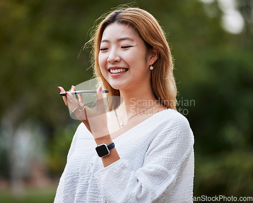 Image of Audio phone call, happy and a woman in nature for communication, chat or voice instruction. Smile, park and an Asian girl speaking on a mobile for networking, audio recording or conversation