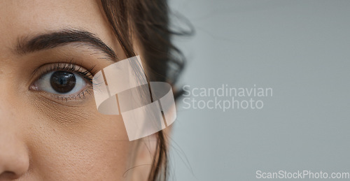 Image of Woman, eye and zoom in portrait by space, mockup or health for vision, contact lens or biometric test. Girl, model and closeup for cybersecurity banner, retina or cornea scan for safety by background