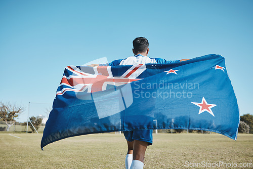 Image of Flag, sports and a man running on a field with a blue sky to celebrate outdoor. Banner, champion and athlete person with patriotism and pride after winning competition to support New Zealand country