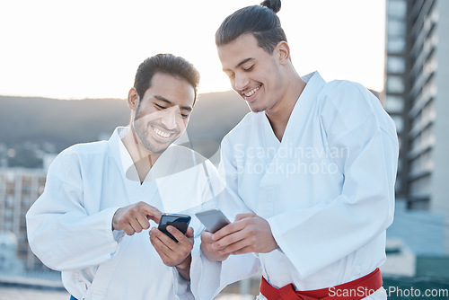 Image of Happy, karate and men with phone in the city for martial arts, app information or social media. Smile, laughing and friends with a mobile for taekwondo training, fitness or a workout check online