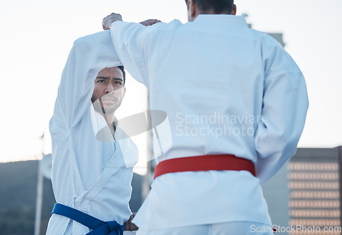 Image of Karate, fight and men in city for exercise, workout and training outdoor. Martial arts, sports and people in competition for taekwondo, serious battle or combat challenge for healthy body in fitness