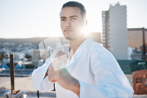 Image of Karate, fitness and hands with a sports man in the city for self defense training or a combat workout. Exercise, health and fighting with a serious young male athlete or warrior in an urban town
