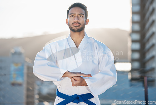 Image of Karate, exercise and focus with a sports man in the city for self defense training or a combat workout. Fitness, health and fighting with a serious young male athlete or warrior in an urban town