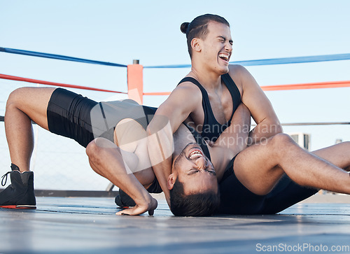 Image of Men, wrestling and competition in a ring, mat or athlete winning in a tournament, match or training on floor of an arena. Fighting, match or championship gym with people grappling together for sport