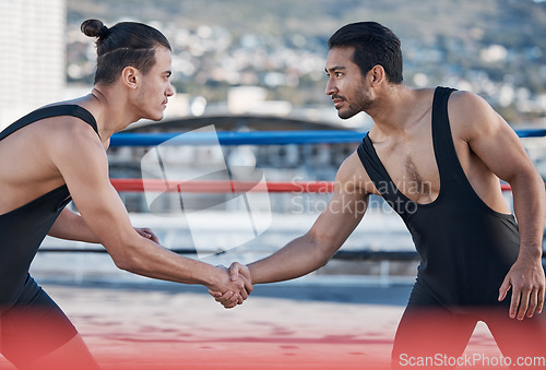 Image of Men, handshake and fight sport in ring, respect or fitness in challenge, battle and gym on roof in cbd. Shaking hands, wrestling coach or friends for contest, exercise or martial arts in Cape Town