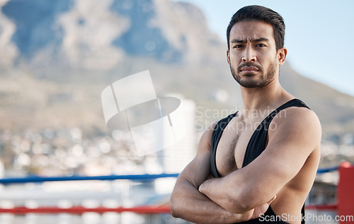 Image of Man, wrestling and arms crossed in portrait for sport, ring and fitness on rooftop, strong muscle and mindset. Young athlete, serious face and healthy body for fight, mma and training in Cape Town