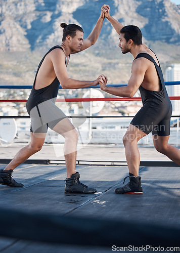Image of Strong men, wrestling and push in ring with challenge, holding hands and focus for contest in Cape Town. Athlete, martial arts and grappling for mma, competition or fight in combat workout on rooftop