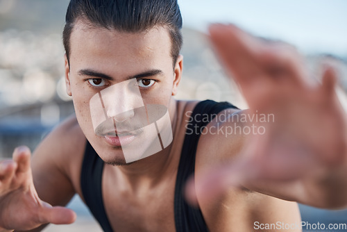 Image of Hands, portrait and a man doing karate in the city, training for taekwondo or sports competition. Serious, fitness and a professional athlete with a move for a workout or martial arts exercise