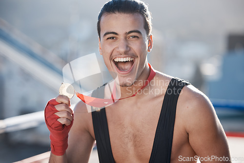 Image of Winner, wrestler or portrait of happy man with medal to celebrate winning a wrestling competition with pride. Success, fitness or excited athlete with fighting victory award, gold or prize in a ring
