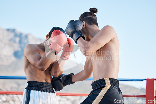 Image of Punch, boxing match or men fighting in sports training, exercise or fist punching with strong power. Fitness action, boxers or combat fighters boxing in practice workout in ring on rooftop in city