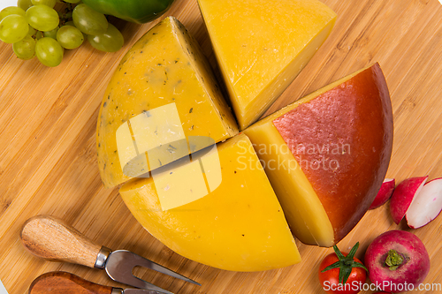 Image of Bosnian traditional cheese served on a wooden container with peppers, parade and onions isolated on a white background