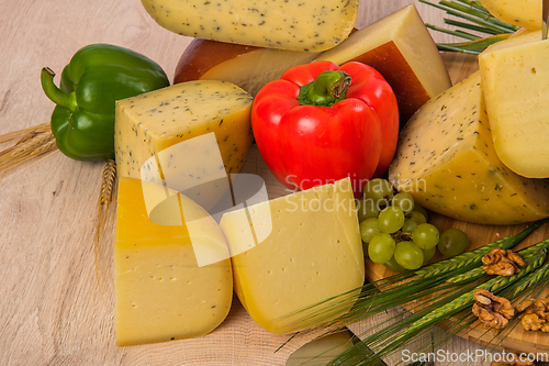 Image of Bosnian traditional cheese served on a wooden container with peppers, parade and onions isolated on a white background