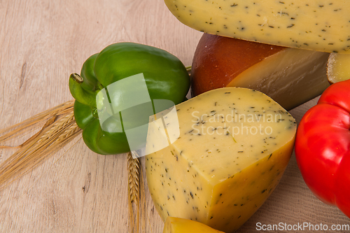 Image of Bosnian traditional cheese served on a wooden container with peppers, parade and onions isolated on a white background