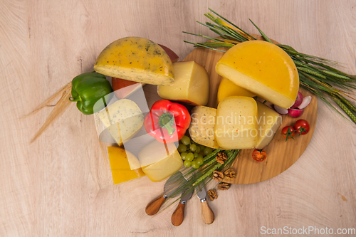 Image of Bosnian traditional cheese served on a wooden container with peppers, parade and onions isolated on a white background