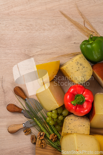 Image of Bosnian traditional cheese served on a wooden container with peppers, parade and onions isolated on a white background