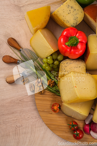 Image of Bosnian traditional cheese served on a wooden container with peppers, parade and onions isolated on a white background