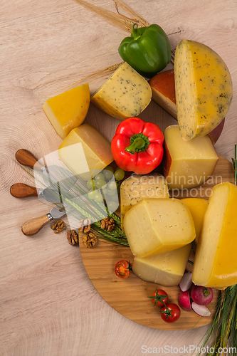 Image of Bosnian traditional cheese served on a wooden container with peppers, parade and onions isolated on a white background