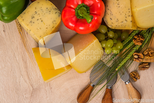 Image of Bosnian traditional cheese served on a wooden container with peppers, parade and onions isolated on a white background