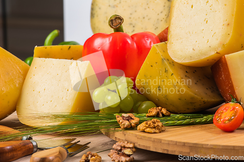 Image of Bosnian traditional cheese served on a wooden container with peppers, parade and onions isolated on a white background