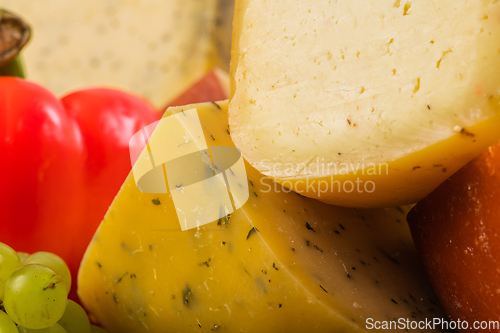 Image of Bosnian traditional cheese served on a wooden container with peppers, parade and onions isolated on a white background