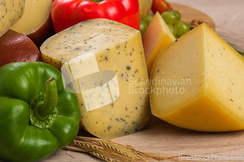 Image of Bosnian traditional cheese served on a wooden container with peppers, parade and onions isolated on a white background