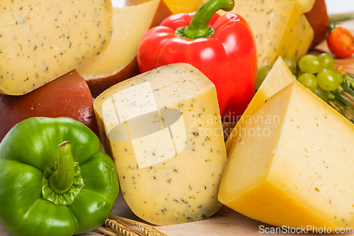 Image of Bosnian traditional cheese served on a wooden container with peppers, parade and onions isolated on a white background