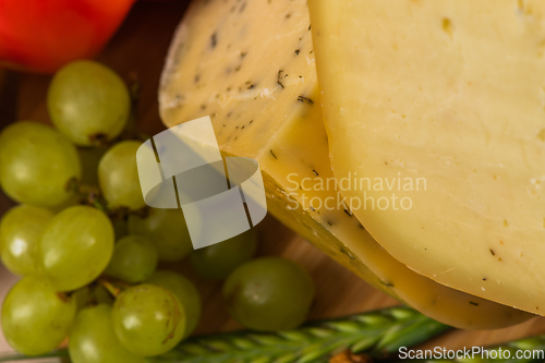 Image of Bosnian traditional cheese served on a wooden container with peppers, parade and onions isolated on a white background