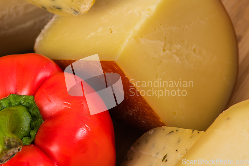 Image of Bosnian traditional cheese served on a wooden container with peppers, parade and onions isolated on a white background