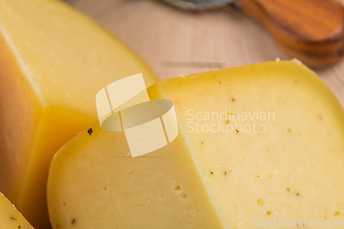 Image of Bosnian traditional cheese served on a wooden container with peppers, parade and onions isolated on a white background