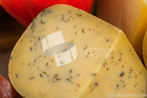 Image of Bosnian traditional cheese served on a wooden container with peppers, parade and onions isolated on a white background