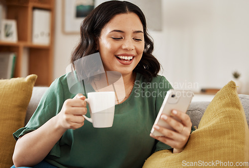 Image of Woman on sofa with phone, coffee and smile, reading email or social media meme in living room. Networking, cellphone and happiness, girl on couch to relax, chat and internet search for post or text.